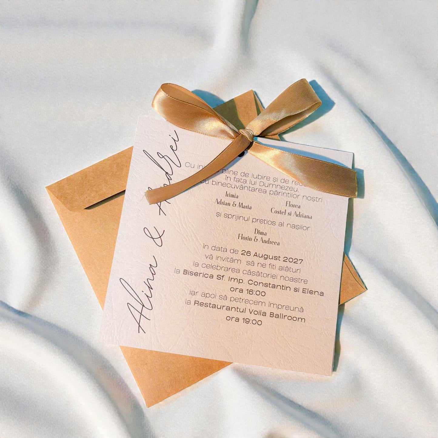 Invitație nuntă elegantă crem cu fundiță aurie și plic kraft natural